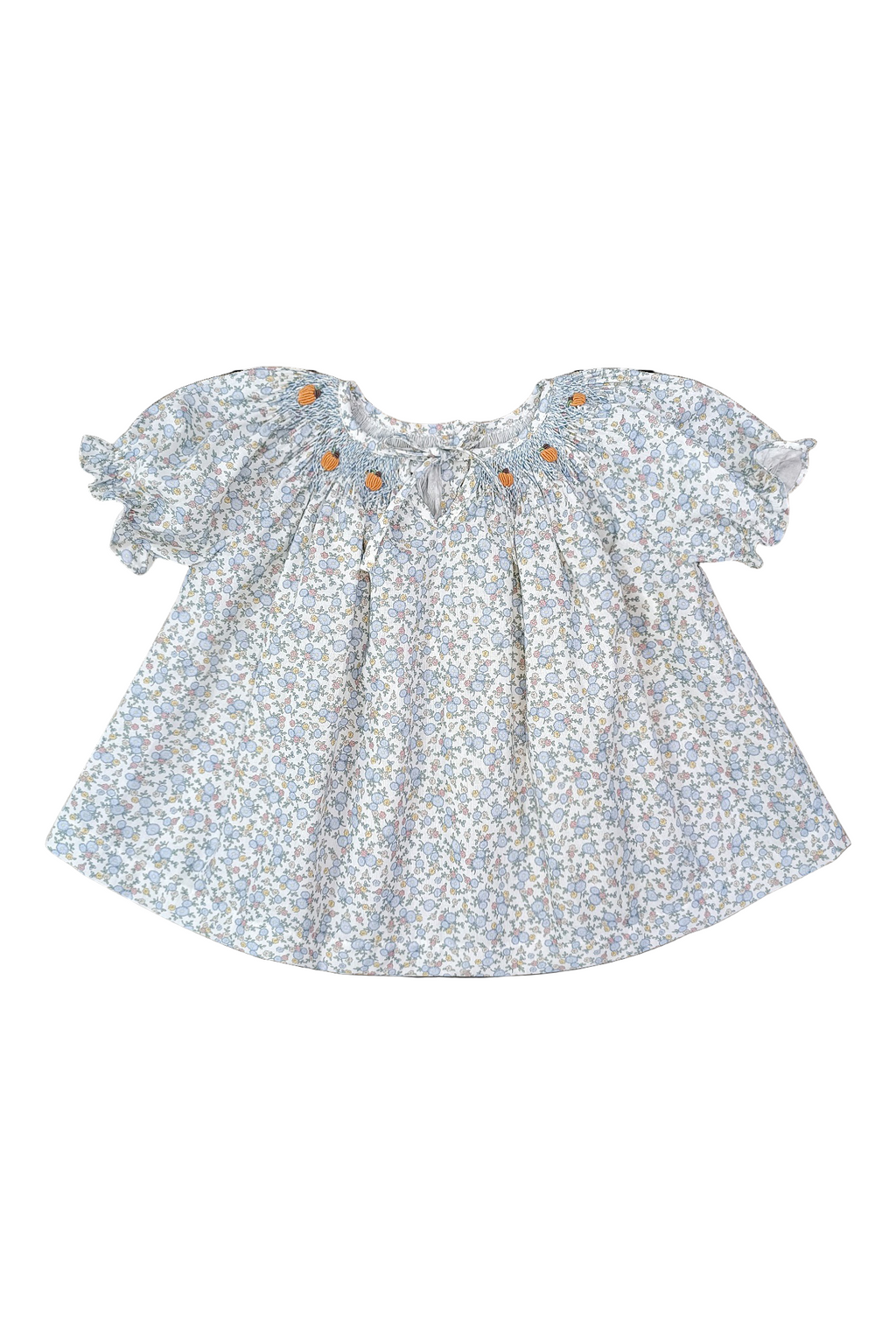 Floral smocked pumpkin blouse with ruffled sleeves on a white background