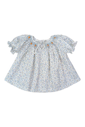 Floral smocked pumpkin blouse with ruffled sleeves on a white background